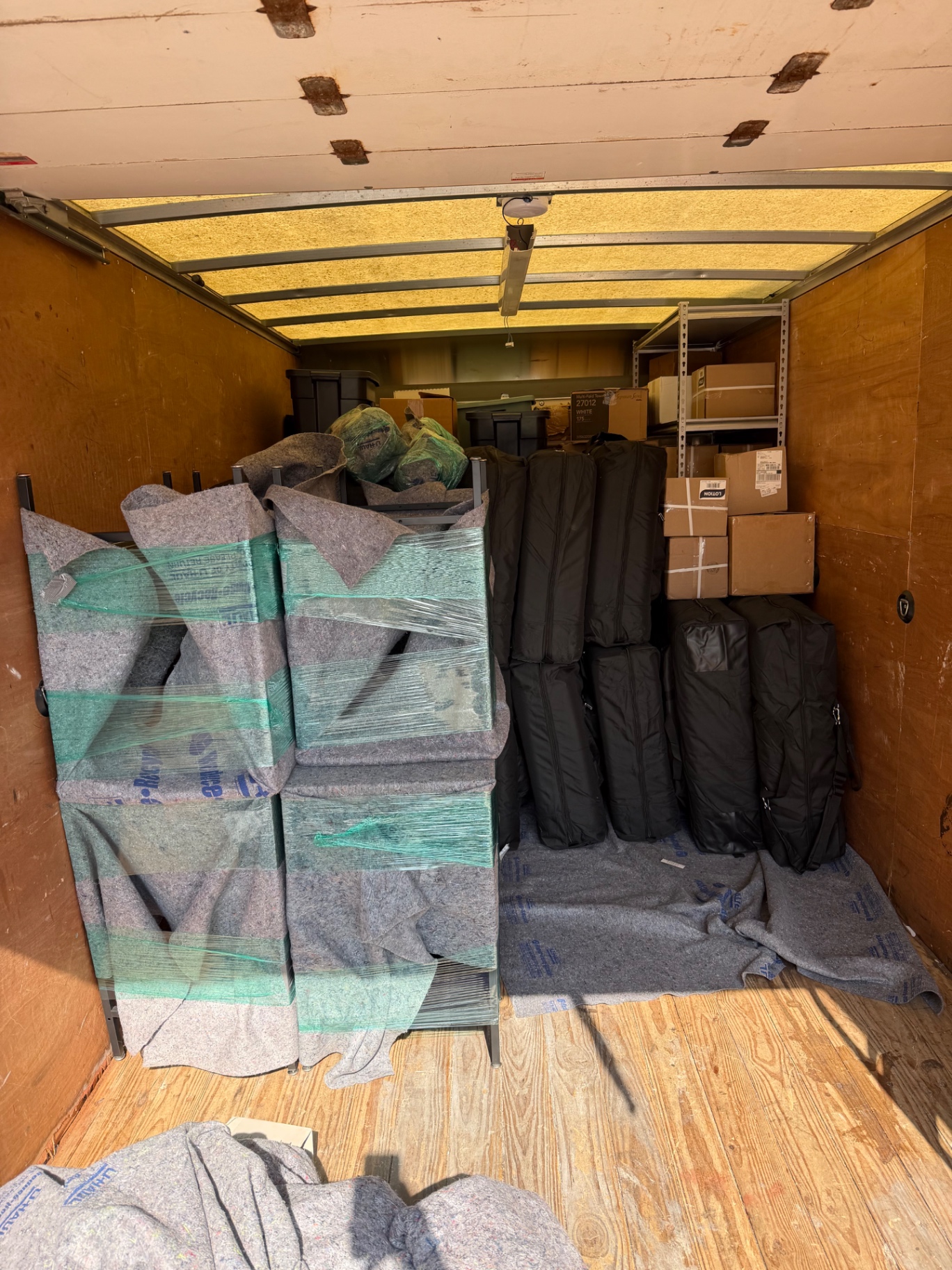 Furniture blanket wrapped and stacked inside a Burray moving truck