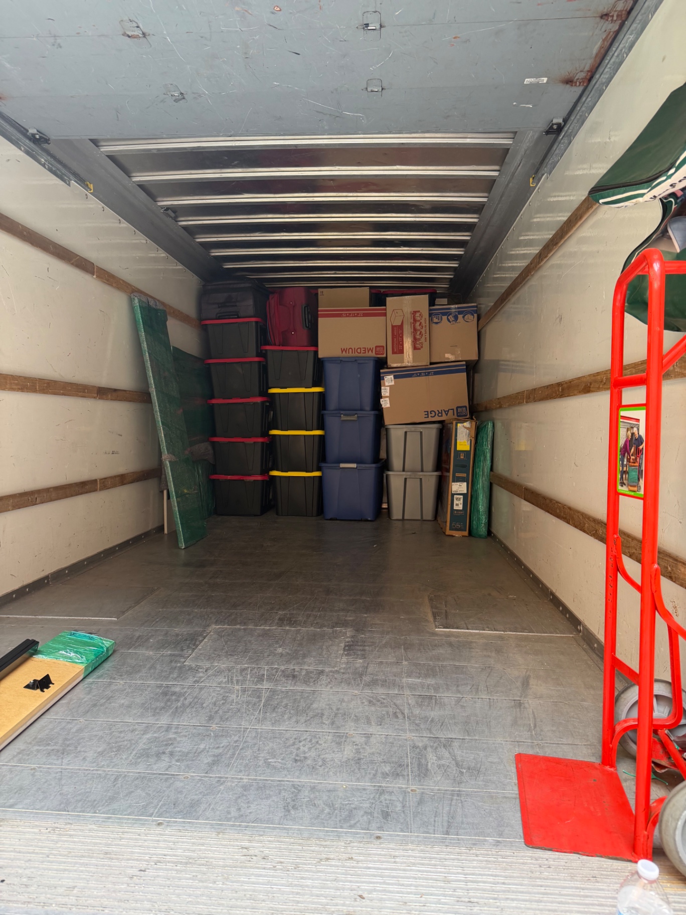 Moving truck loaded with neatly stacked boxes and totes by Burray Moving